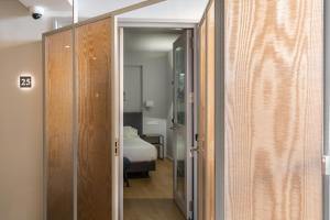 a door leading into a room with a bed at Posada Sillería - Historic boutique Hotel in Toledo +80 photos