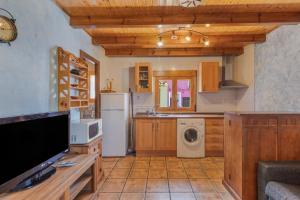 a kitchen with a refrigerator and a washer and dryer at El Alarife in Sediles