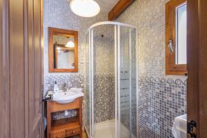 a bathroom with a glass shower and a sink at El Alarife in Sediles +23 photos