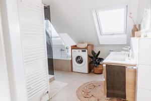 a bathroom with a washing machine and a sink at Wohnung am Bodensee in Moos +17 photos