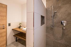 a bathroom with a shower and a sink at Ferienwohnung am Mühlbachl in Rohrberg +22 photos
