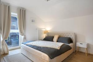 a bedroom with a large bed with a window at Haus Rübezahl in Bayerisch Gmain