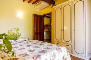 a bedroom with a bed and a cabinet at Il Gaggiolo 2 in Grosseto +12 photos