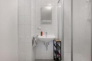 a white bathroom with a sink and a shower at Haus Rübezahl in Bayerisch Gmain +49 photos