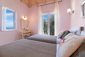 a bedroom with two beds and a window at Villa Belvedere Rosa in Lefkada +19 photos