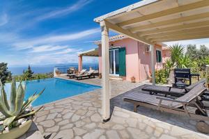 a villa with a swimming pool and a pergola at Villa Belvedere Rosa in Lefkada