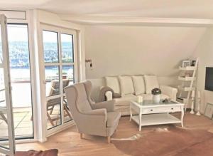 a living room with a couch and a table at Apartment Blackforest-Schluchsee in Schluchsee