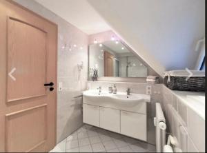 a white bathroom with a sink and a mirror at Apartment Blackforest-Schluchsee in Schluchsee