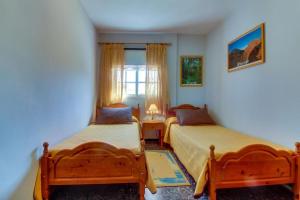 a bedroom with two beds and a window at Villa Morera in Arafo +21 photos