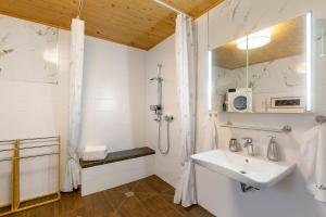 a white bathroom with a sink and a shower at Ferienwohnung Haus Luise in Olsberg +25 photos