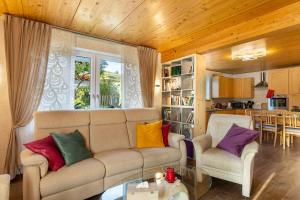 a living room with a couch with colorful pillows at Ferienwohnung Haus Luise in Olsberg