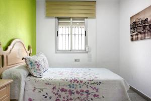 a bedroom with a bed and a window at Casa Unifamiliar Rio Barbate in Barbate +11 photos