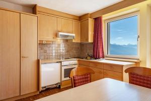 a small kitchen with a table and a window at Apt Waldblick in Maranza