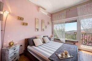 a bedroom with a bed and a large window at Ca dei Tati -Citr 1181 with Jacuzzi in Imperia