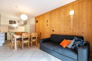 a living room with a couch and a table at Apartment Sassolungo in Campitello di Fassa