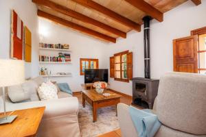a living room with a couch and a stove at Finca Rural Es Pujol in Sóller