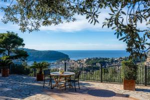 a table and chairs on a patio with a view of the city at Finca Rural Es Pujol in Sóller