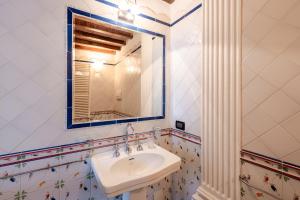 a bathroom with a sink and a mirror at Romantic Apartment Near Pisa Lucca in Bientina +13 photos