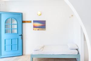 a bedroom with a blue door and a bed at Beachfront Lampis Dolphin 1 in Skala +21 photos