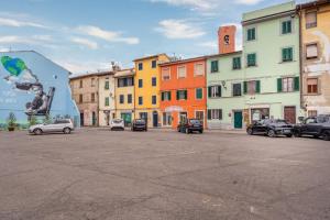 a parking lot with cars parked in front of buildings at Romantic Apartment Near Pisa Lucca in Bientina