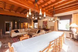 a living room with a large dining room table at Can Vilallonga in Sant Feliu de Pallerols