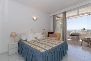 a bedroom with a bed with a view of the ocean at Marina view apartment in Fuengirola