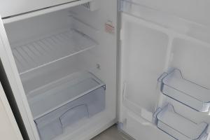 an empty white refrigerator with its door open at La Maison Defanny - 2 in Muides-sur-Loire
