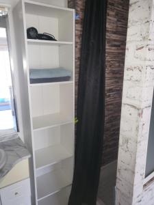 a white book shelf in a room at La Maison Defanny - 2 in Muides-sur-Loire