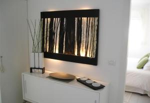 a room with a bed and a table with a mirror at Nueva Baviera 42 in San Bartolomé +8 photos