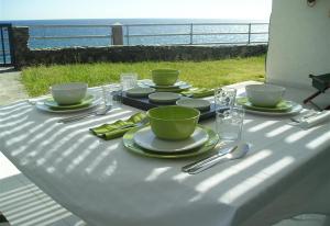 a table with a white table cloth with a view of the ocean at Nueva Baviera 42 in San Bartolomé
