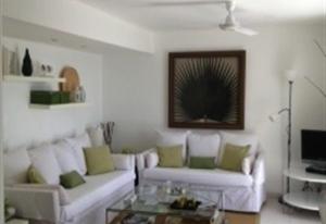 a living room with two white couches and a coffee table at Nueva Baviera 42 in San Bartolomé