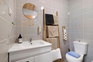a bathroom with a sink and a toilet and a mirror at Casa Gotinha d' Água in Alcaria Ruiva +22 photos