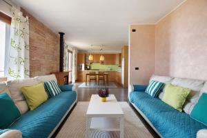 a living room with blue couches and a table at Casa Giuly in Stazzona