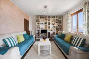 a living room with two couches and a table at Casa Giuly in Stazzona