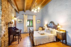 a bedroom with a bed and a desk and a piano at Casa Romaní in El Bruc +23 photos