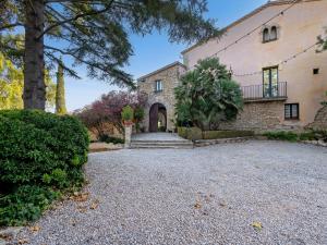 a large stone house with a driveway at Casa Romaní in El Bruc