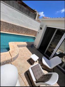 a patio with chairs and a swimming pool at Sam in San Fulgencio