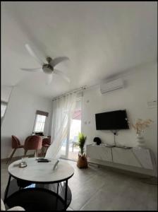 a white living room with a tv and a table at Sam in San Fulgencio