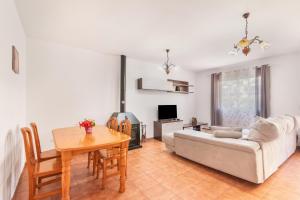 a living room with a couch and a table at Duplex Islantilla con piscina in Islantilla