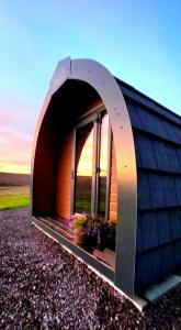 a building with an arched window with flowers in it at The Westings in Tingwall +65 photos