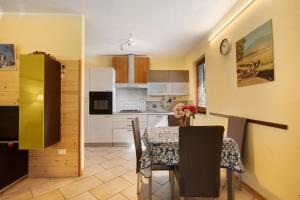 a kitchen and dining room with a table and chairs at Maison Chateau Chatillon in Châtillon