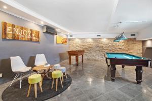a room with a pool table and chairs at Sunshine Villa em Vilamoura in Vilamoura