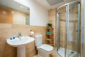 a bathroom with a sink toilet and a shower at Duplex La Nau By homevillas360 in Port de Pollensa +19 photos