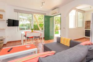 a living room with a couch and a table at Villa Elfa in Cala en Forcat