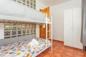 a bedroom with a bunk bed in a room at Villa Elfa in Cala en Forcat +16 photos