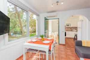 a living room with a table and a couch at Villa Elfa in Cala en Forcat