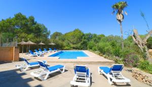 a group of lounge chairs and a swimming pool at Can Palea in Campos