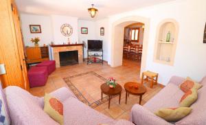 a living room with a couch and a fireplace at Can Palea in Campos