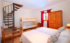 a bedroom with a bunk bed and a spiral staircase at Can Palea in Campos +33 photos