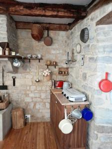 a kitchen with a counter and a stone wall at La Petite Authentique in Gaillac-dʼAveyron